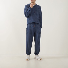 Model wearing Paul Smith Access blue modal hoodie top with matching blue cargo-style joggers and white trainers.
