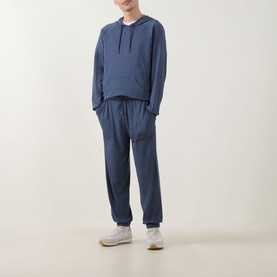 Model wearing Paul Smith Access blue modal hoodie with matching blue joggers and white trainers.