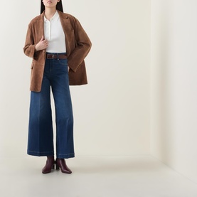 Model wearing Spanx E.W 2.0 Wide Leg Petite Jeans in Poseidon, styled with a brown blazer and burgundy ankle boots.
