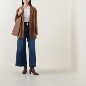 Model wearing Spanx E.W 2.0 Wide Leg Petite Jeans in Poseidon, styled with a tan blazer, white shirt and burgundy ankle boots.