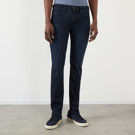 Model wearing Paige Lennox Slim-Leg Jeans in Hastings dark-wash denim, styled with white trainers