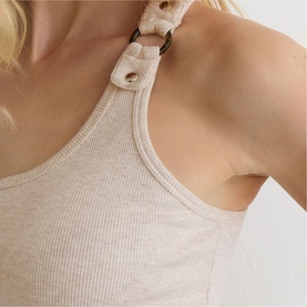 Model wearing Reiss neutral marl ribbed vest top, close-up detail of ring-embellished halter neckline strap.