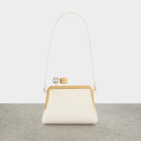 Jacquemus Le Berlingot Crossbody Bag in light ivory nappa leather, gold-tone frame clasp with pearl detail, adjustable shoulder strap