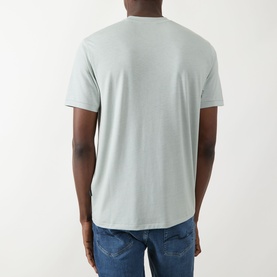 Model wearing Seven Jeans Dusty Blue Crew Neck T-shirt, back view, styled with blue jeans