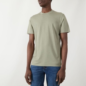 Model wearing Seven Jeans Army Crew Neck T-shirt in sage green, styled with blue denim jeans.