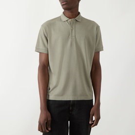 Model wearing Seven Jeans Army Regular Polo in sage green piqu&eacute; fabric, styled with black jeans, short sleeves and ribbed collar.