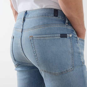 Model wearing Seven Jeans 3049 Slim Jeans in Haven light blue wash, close-up of rear pocket detail
