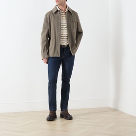 Model wearing Seven Jeans Sundown straight jeans in dark indigo, styled with a taupe harrington jacket, stripe top and brown boots.