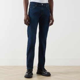 Model wearing Seven Jeans straight-leg jeans in Indigo Minty, styled with black leather shoes.