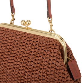 Coach Kisslock Frame 27 Woven Bag in clay paper straw with gold-tone kisslock clasp, tan leather strap and branded swingtag