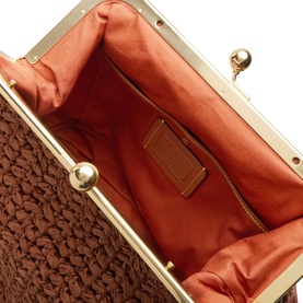 Coach Kisslock Frame 27 Woven Bag in Clay, interior view showing coral lining, tan leather label patch and gold-tone kisslock hardware frame.