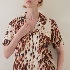 Model wearing Desmond & Dempsey Leopard Brown pyjama top, notched collar, short sleeves, front button fastening and chest patch pocket.