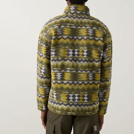 Model wearing Columbia Helvetia Half-Buttoned Logo Printed Fleece Sweatshirt in Mossy Green with geometric pattern, back view, styled with khaki