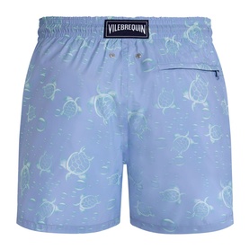 Vilebrequin swim shorts in cloudy blue with all-over green turtle print, rear view showing back pocket and logo patch.