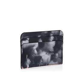 Christian Louboutin card holder in black and white abstract print, slim flat profile with multiple card slots and red trim detail.