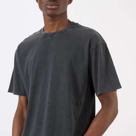 Model wearing Edwin Axiom Logo T-Shirt in dark grey, cropped shot showing crew neck and short sleeves with garment-dyed finish.