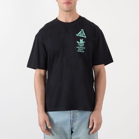 Model wearing Edwin Hardware Store Logo T-Shirt in black, crew neck with teal chest graphic, styled with light blue jeans.