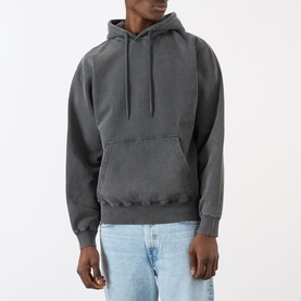 Model wearing Edwin Axiom Logo Hoodie in dark grey with drawstring hood and kangaroo pocket, styled with light wash jeans.