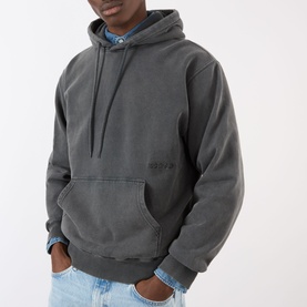 Model wearing Edwin Axiom Logo Hoodie in dark grey with kangaroo pocket and embroidered logo, styled with denim shirt