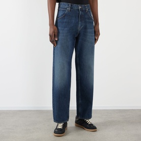 Model wearing Edwin Tyrell High-Rise Straight Leg Jeans in blue nix wash, loose straight-leg cut with faded whiskering details, styled with dark