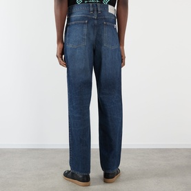 Model wearing Edwin Tyrell High-Rise Straight Leg Jeans in Blue Nix Wash, rear view showing logo badge, belt loops and straight-leg cut.