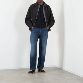 Model wearing Edwin Tyrell High-Rise Straight Leg Jeans in blue nix wash with dark jacket and black shoes.