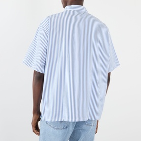 Model wearing Edwin Toledo Stripe Shirt in blue, short-sleeve cotton shirt with vertical stripes, back view, styled with light wash jeans