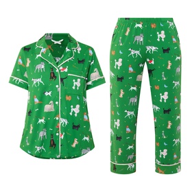 Kate Spade Dog Park pyjama set in green with all-over dog print, short-sleeve button-up top and cropped trousers with white piping trim