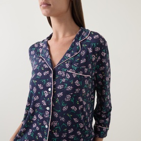 Model wearing Kate Spade Lively Blooms Tossed pyjama shirt in navy with pink floral print and white piped collar detail.