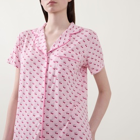 Model wearing Stripe & Stare Cherry Short Pyjama Set in Cherry Baby, showing notched lapel top with short sleeves, button front and cherry print
