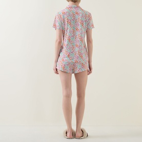 Model wearing Stripe & Stare Sweet Posy Short Pyjama Set in floral print, back view; styled with slider sandals