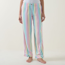 Model wearing Stripe & Stare Soft Brushed Stripe Pyjama Bottoms in Roller Stripe, full-length with elasticated waistband and logo badge.