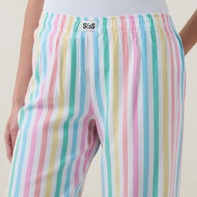 Model wearing Stripe & Stare Soft Brushed Stripe Pyjama Bottoms in Roller Stripe, showing elasticated waistband with logo badge detail.
