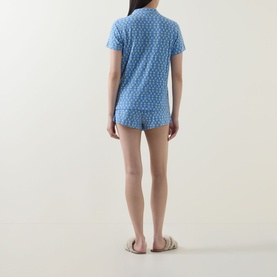 Model wearing Stripe & Stare Sorento Lemon pyjamas, back view, short-sleeve shirt and shorts set with ditsy print, styled with slides.