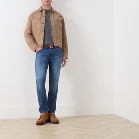 Model wearing Nudie Jeans Roy Take It Easy Logo T-Shirt in Antracite, styled with tan suede jacket, blue jeans and brown boots.