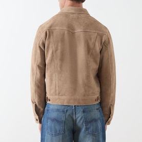 Model wearing Nudie Jeans Casual Jacket in Mud, rear view, suede-effect tan finish with waist hem adjuster, styled with blue jeans.