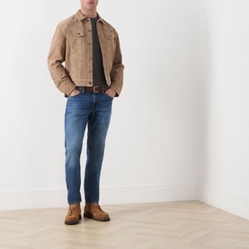 Model wearing Nudie Jeans Gritty Jackson Straight-Leg Jeans in Sun Set, dark wash, styled with a tan suede jacket and brown boots.