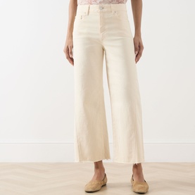 Model wearing Paige Anessa Front Pockets High-Rise Wide Leg Jeans in Butter Yellow, cropped wide leg with raw hem, styled with a pink top.