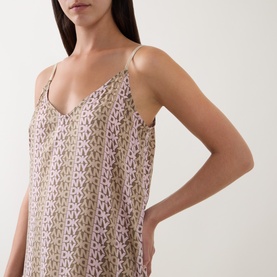 Model wearing DKNY Dusky Green Logo Stripe chemise, featuring V-neck, thin straps, and all-over logo print.
