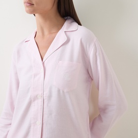 Model wearing Lauren pink print pyjama shirt, long-sleeved with classic collar, chest pocket, and button-front detail in cotton-viscose blend.