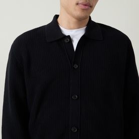 Model wearing Boss Black Casual Laconico Knitted Polo Cardigan in black, showing ribbed knit texture, polo collar and front button fastening over