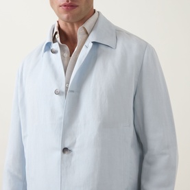 Model wearing Boss Black Casual Open Blue lyocell-linen casual jacket with button front, styled over a light shirt