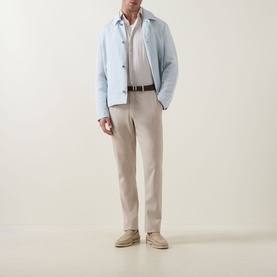 Model wearing Boss Black Casual Open Blue lyocell-linen casual jacket, styled with cream trousers, white shirt and brown belt.