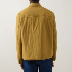 Model wearing Boss Black Casual gold casual jacket, rear view, shown with blue jeans. Lightweight padded polyester with shirt collar.