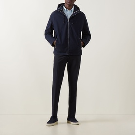 Model wearing Boss Black Casual dark blue casual jacket with zip front and hood, styled with navy trousers and slip-on shoes.