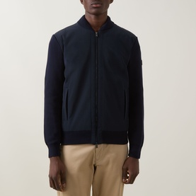 Model wearing Boss Black Casual dark blue cotton casual jacket with zip front, ribbed collar and cuffs, styled with beige trousers.