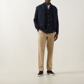 Model wearing Boss Black Casual Dark Blue Casual Jacket, styled with beige chinos, white T-shirt, and navy trainers.