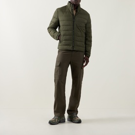 Model wearing Boss Black Casual Open Green quilted casual jacket with cargo trousers and grey trainers.
