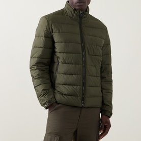 Model wearing Boss Black Casual Open Green quilted casual jacket with zip fastening, styled with matching khaki trousers.