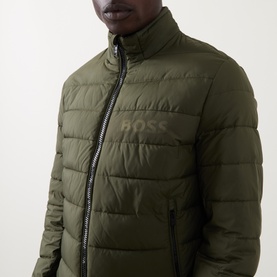 Model wearing Boss Black Casual Open Green quilted casual jacket with tonal logo print and zip fastening, funnel neck.